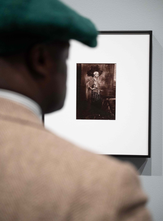 Dandy Wellington looks at James Van Der Zee’s Dancer (1925), a photograph of Florence Mills.