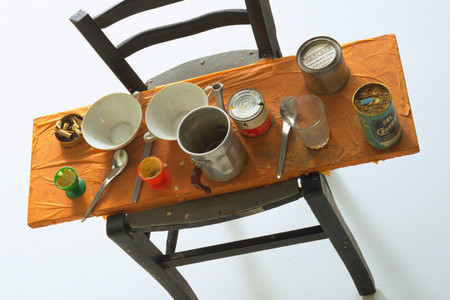 Daniel Spoerri. Kichka&#39;s Breakfast I. 1960. Wood chair hung on wall with board across seat, coffeepot, tumbler, china, eggcups, eggshells, cigarette butts, spoons, tin cans, and other materials, 14 3/8 x 27 3/8 x 25 3/4&#34; (36.6 x 69.5 x 65.4 cm). Philip Johnson Fund. © 2025 Daniel Spoerri / Artists Rights Society (ARS), New York / ProLitteris, Switzerland