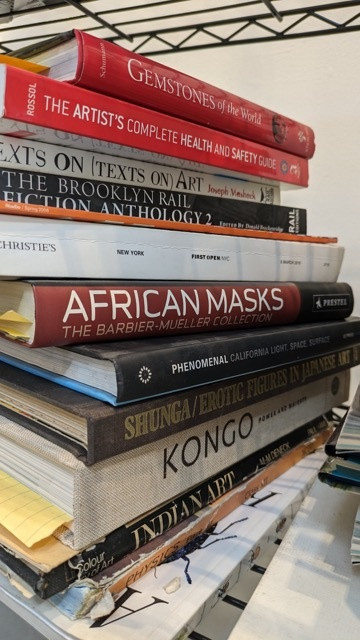 A stack of Whitten’s books at his studio in Queens, New York, 2024