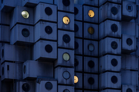 Night time at the Nakagin Capsule Tower, with Mr. Takayuki Sekine seen through the window of capsule B1004, 2016. © Jeremie Souteyrat