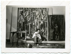 Wifredo Lam with La Jungla (The Jungle, 1942–43), Le matin vert(The Green Morning, 1943), and on the floor, La Silla (The Chair, 1943), in his Havana studio, 1943. Archives SDO Wifredo Lam, Paris.