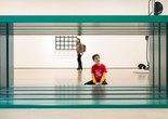 A child sits looking at Donald Judd’s untitled green, rectangular sculpture. Photo: On White Wall, Inc.
