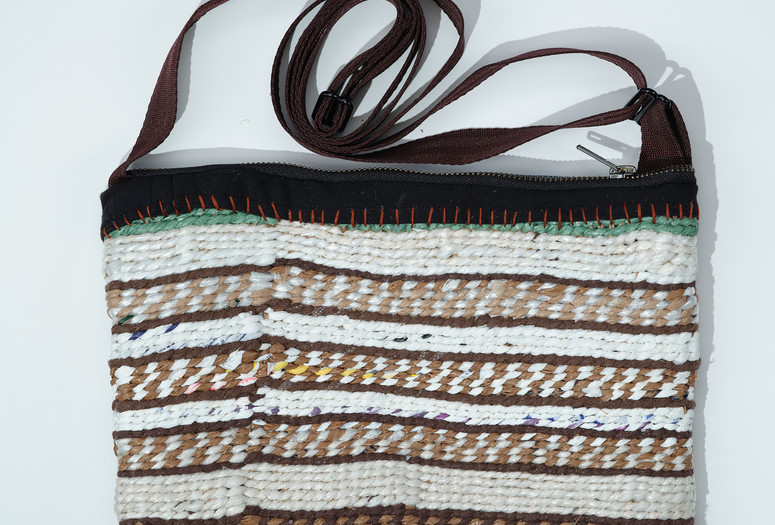 A colorful hand-woven bag with horizontal stripes. Image courtesy of Kris Waymire, 2025