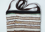 A colorful hand-woven bag with horizontal stripes. Image courtesy of Kris Waymire, 2025