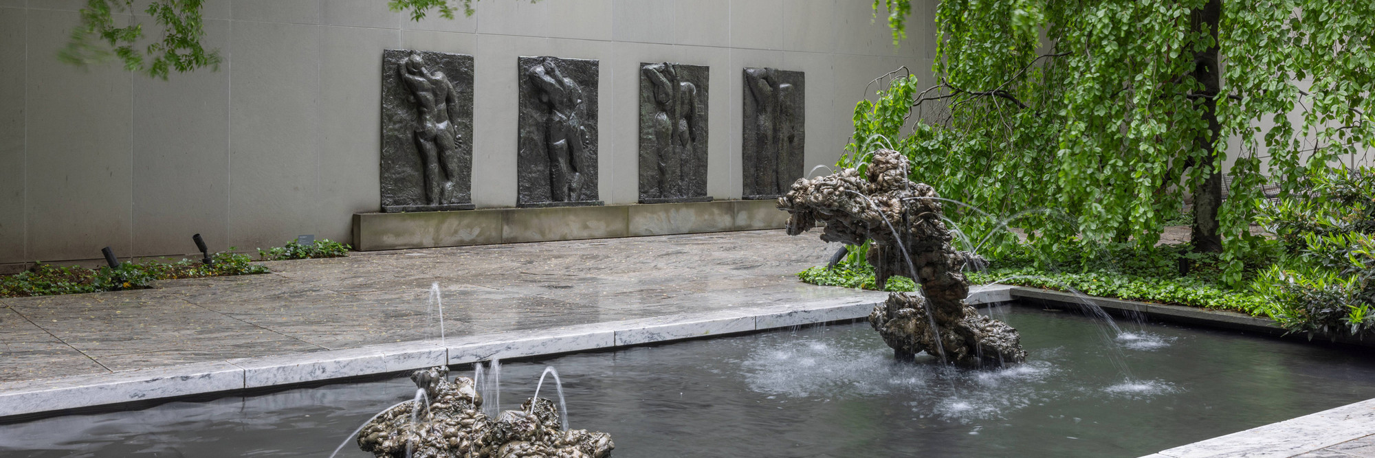 The Abby Aldrich Rockefeller Sculpture Garden, May 2024. Photo: Jonathan Dorado. Shown: Lynda Benglis. Double Fountain, Mother and Child. 2007. Bronze, in two parts. The Museum of Modern Art, New York. Gift of the artist and the Fuhrman Family Foundation; Henri Matisse. The Back (I). Spring 1908–late 1909; The Back (II). 1911 (?)–early March or April 1913; The Back (III). May 13, 1913–early fall 1916; The Back (IV). c. 1931. Bronze. The Museum of Modern Art, New York. Mrs. Simon Guggenheim Fund. © 2025 Succession H. Matisse/Artists Rights Society (ARS), New York