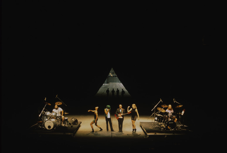 Mike Kelley, Anita Pace, Stephen Prina. Beat of the Traps. 1992. Performed in Expanded Art, Wiener Festwochen, The Remise, Vienna, Austria, 1992. Performers (from left): Jonathan “Butch” Norton, Carl Burkley, Alan Abelew, Stephen Prina, Anita Pace, M.B. Gordy. Photo: Karl Krauss. © 2025 Mike Kelley Foundation for the Arts. All Rights Reserved/Licensed by VAGA at Artists Rights Society (ARS), NY, Anita Pace, Stephen Prina