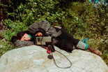 Alanis Obomsawin rests on a rock beside the Lake of Two Mountains, Kanehsatake, 1990. Photo: John Kenney