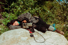 Alanis Obomsawin rests on a rock beside the Lake of Two Mountains, Kanehsatake, 1990. Photo: John Kenney