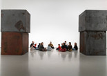 A group of families sit in a gallery featuring Richard Serra’s large sculpture Equal. Photo: Martin Seck