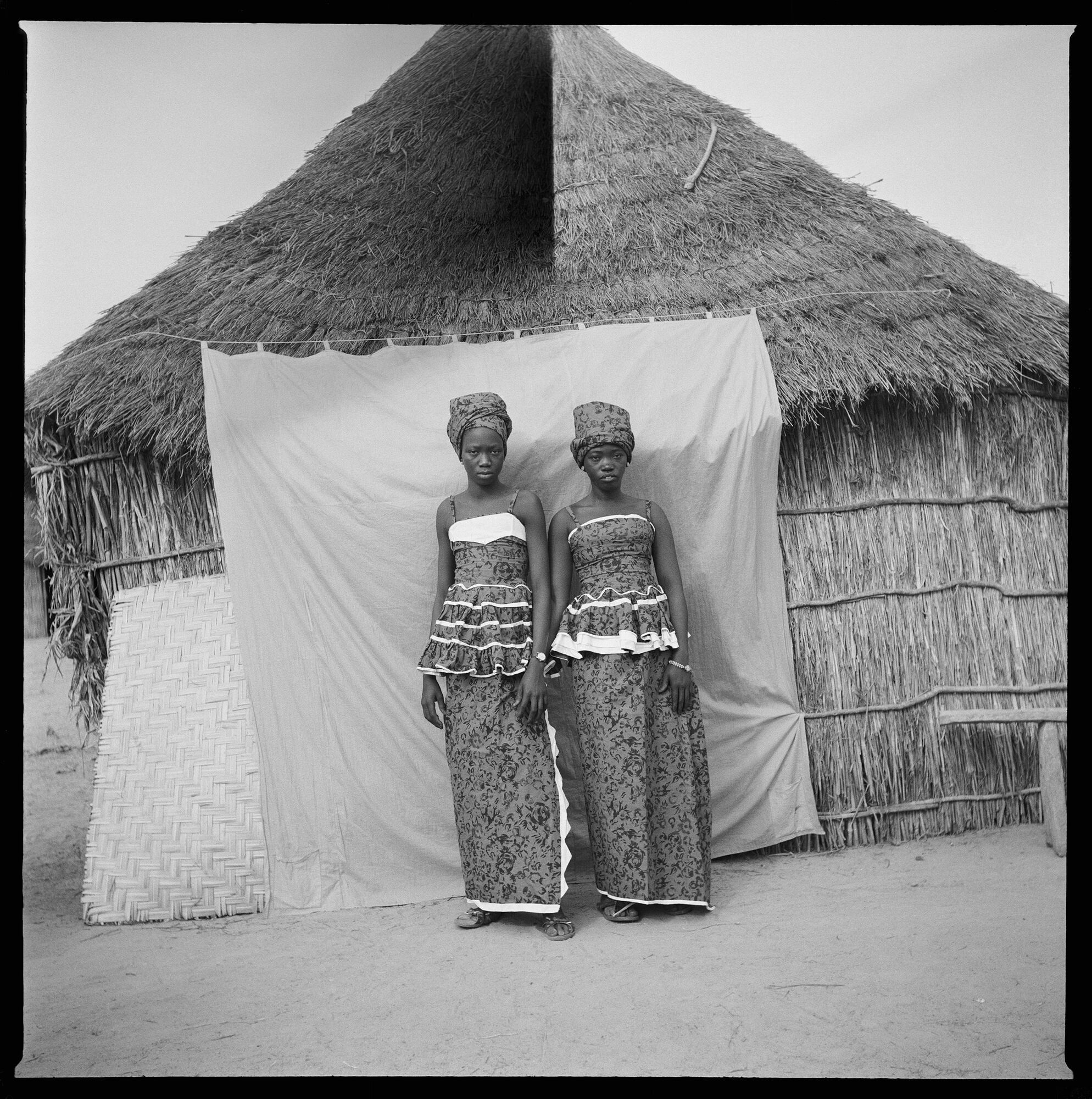 *Untitled (Two Women with Thatched Roof House)*