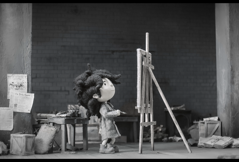 Uka. 2016. Spain. Directed by Valle Comba Canales. Courtesy of Cítrico Studio SLU. Image description: A black-and-white image of a little girl standing at a canvas with a paintbrush in her hand