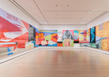 James Rosenquist. F-111. 1964–65. Oil on canvas with aluminum, 23 sections. The Museum of Modern Art New York. Gift of Mr. and Mrs. Alex L. Hillman and Lillie P. Bliss Bequest (both by exchange). © 2025 James Rosenquist/Licensed by VAGA, New York, NY. Installation view, photographed in October 2022. Photo: Emile Askey. Digital Image © 2025 The Museum of Modern Art, New York. Image description: A long, brightly colored painting hangs across three walls in a gallery.