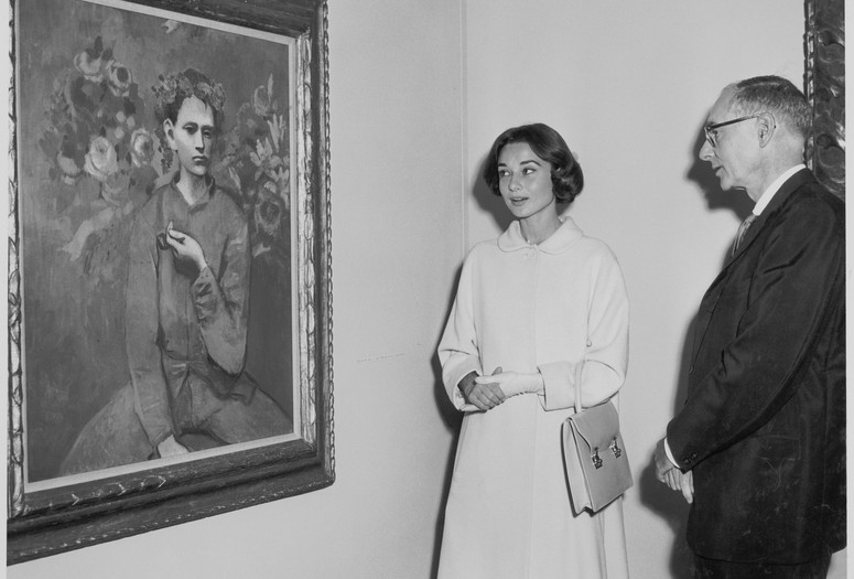 Audrey Hepburn and Alfred H. Barr Jr. at the exhibition Picasso: 75th Anniversary. 1957. Photographic Archive. The Museum of Modern Art Archives, New York. Photo: Barry Kramer