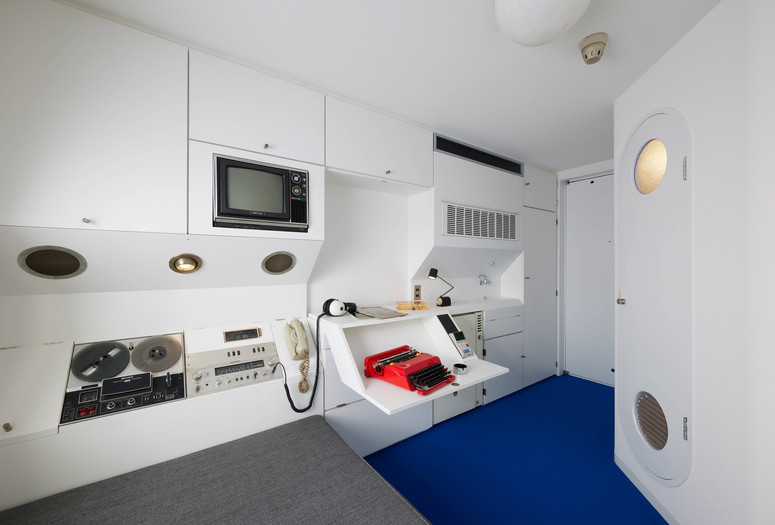Kisho Kurokawa, Architect &amp; Associates (Tokyo, est. 1962). Capsule A1305 from the Nakagin Capsule Tower. 1970–72; restored 2022–23. Steel, wood, paint, plastics, cloth, polyurethane, glass, ceramic, and electronics.The Museum of Modern Art, New York. Gift of Jo Carole and Ronald S. Lauder, Alice and Tom Tisch, and the Nakagin Capsule Tower Preservation and Restoration Project, Tokyo