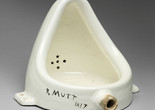 Marcel Duchamp. Fountain. 1950 (replica of 1917 original). Porcelain urinal. Philadelphia Art Museum: 125th Anniversary Acquisition. Gift (by exchange) of Mrs. Herbert Cameron Morris. © Association Marcel Duchamp/ADAGP, Paris/Artists Rights Society (ARS), New York 2026 Image description: A white porcelain urinal turned 90 degrees so it sits on the flat side that would have been flush against the wall. The words “R. Mutt 1917” are written in thick black paint on the rim of the base.
