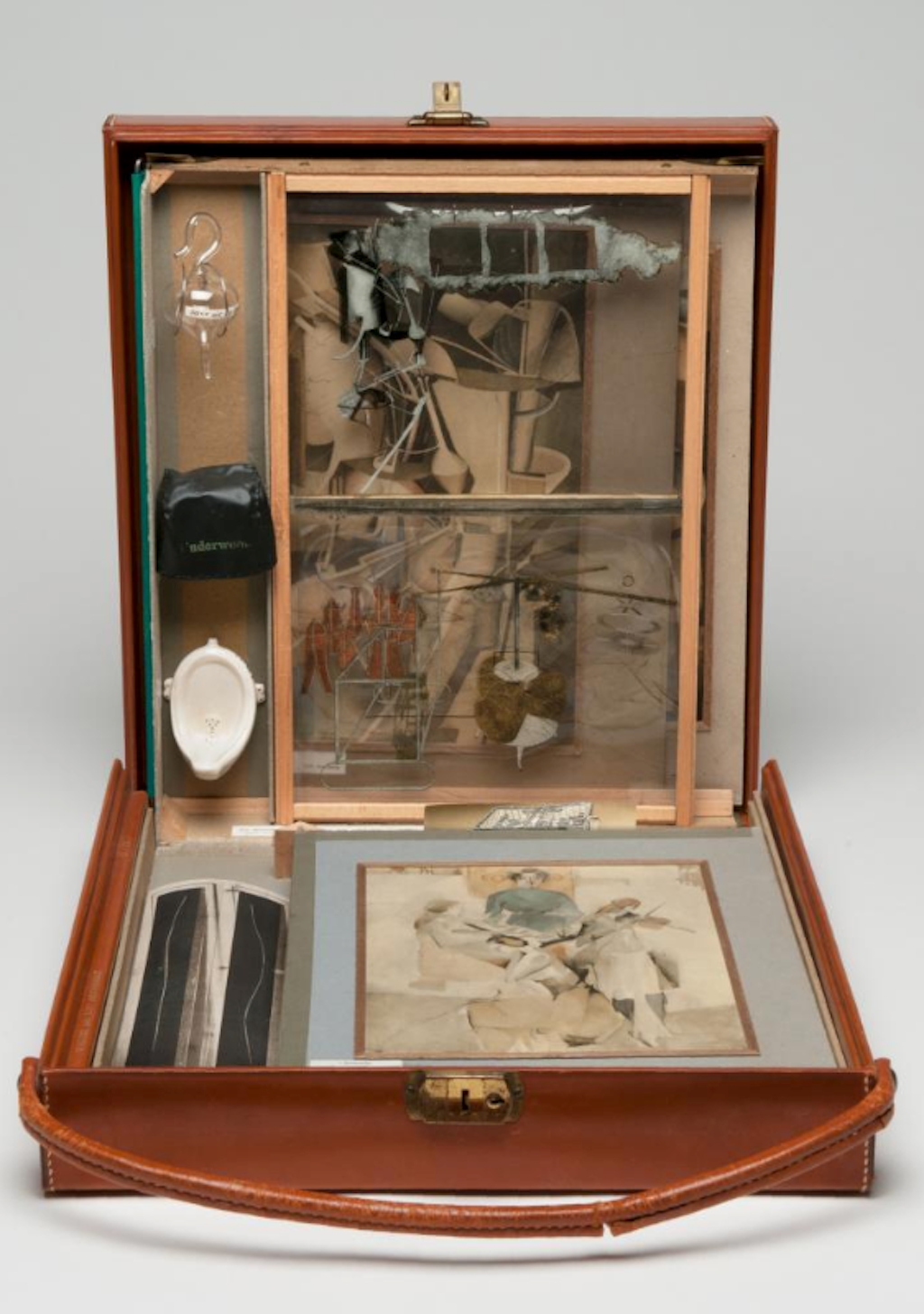 Marcel Duchamp. *From or by Marcel Duchamp or Rrose Sélavy (Box in a Valise)*. 1935–41. Brown leather valise with handle containing sixty-nine miniature replicas and printed reproductions and one original, Virgin (No. 2), 1938, hand-colored collotype. Valise (closed): 16 × 14 3/4 × 4 1/4" (40.6 × 37.5 × 10.8 cm). Philadelphia Museum of Art: The Louise and Walter Arensberg Collection, 1950