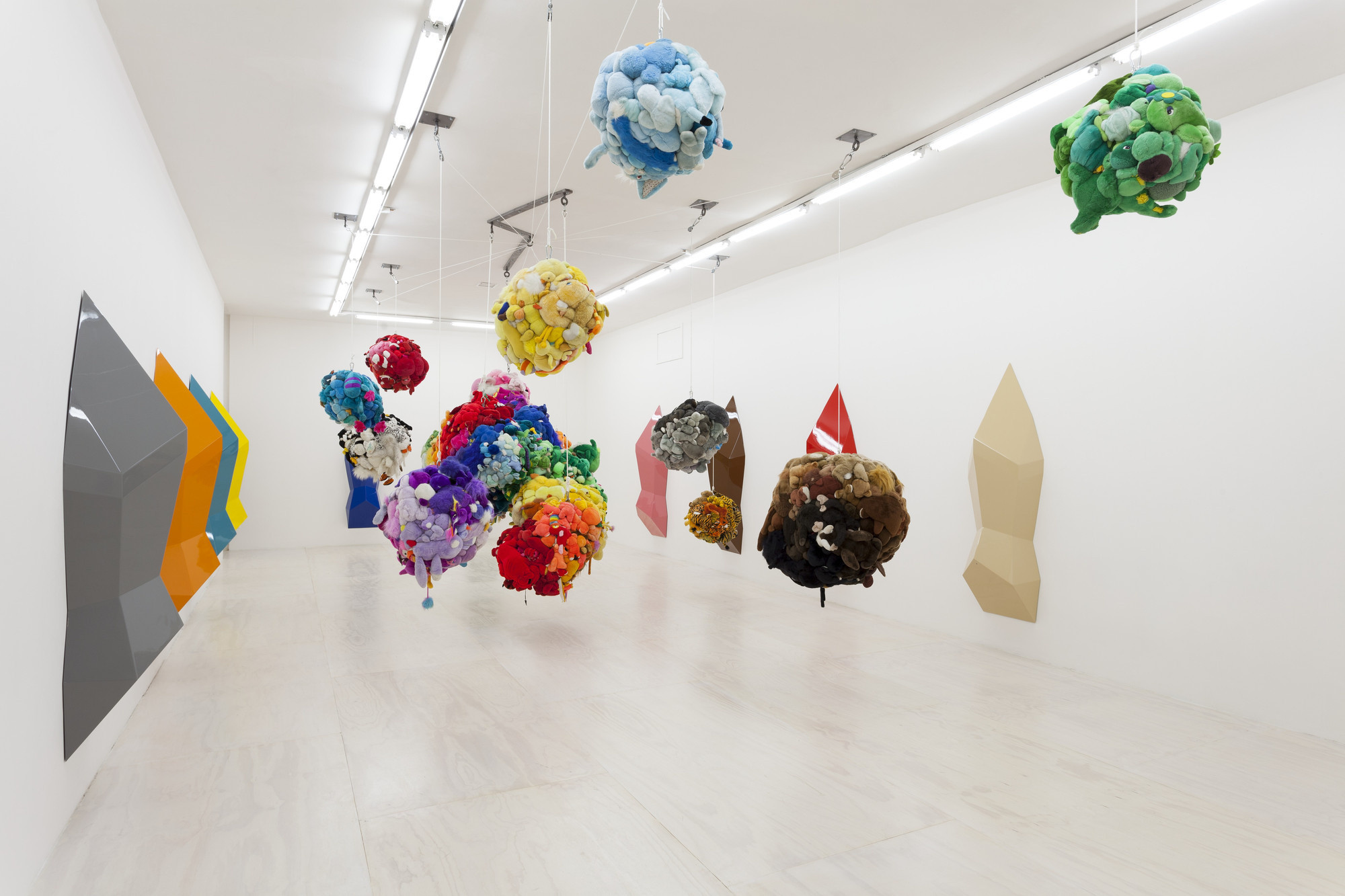 Mike Kelley. *Deodorized Central Mass with Satellites*. 1991/1999. Plush toys sewn over wood and wire frames with styrofoam packing material, nylon rope, pulleys, steel hardware and hanging plates, fiberglass, car paint, and disinfectant, Overall dimensions variable. Partial gift of Peter M. Brant, courtesy the Brant Foundation, Inc. and gift of The Sidney and Harriet Janis Collection (by exchange), Mary Sisler Bequest (by exchange), Mr. and Mrs. Eli Wallach (by exchange), The Jill and Peter Kraus Endowed Fund for Contemporary Acquisitions, Anne and Joel Ehrenkranz, Mimi Haas, Ninah and Michael Lynne, and Maja Oeri and Hans Bodenmann
