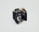 Christopher Williams. Cutaway model Nikon EM. 2008. Shutter: Electronically governed Seiko metal blade shutter vertical travel with speeds from 1/1000 to 1 second with a manual speed of 1/90th; meter: Center-weighted Silicon Photo Diode, ASA 25-1600, EV2-18 (with ASA film and 1.8 lens), Aperture Priority automatic exposure; lens mount: Nikon F mount, AI coupling, (and later) only; flash: Synchronization at 1/90 via hot shoe, Flash automation with Nikon SB-E or SB-10 flash units; focusing: K type focusing screen, not user interchangeable, with 3mm diagonal split image rangefinder; batteries: Two PX-76 or equivalent, 5.3 × 3.38 × 2.13" (135 × 86 × 54 mm). Photography by the Douglas M. Parker Studio, Glendale, California, September 9, 2007–September 13, 2007. Chromogenic print. The Museum of Modern Art, New York. Acquired through the generosity of Helen Kornblum in honor of Roxana Marcoci and Committee on Photography Fund. © 2026 Christopher Williams
