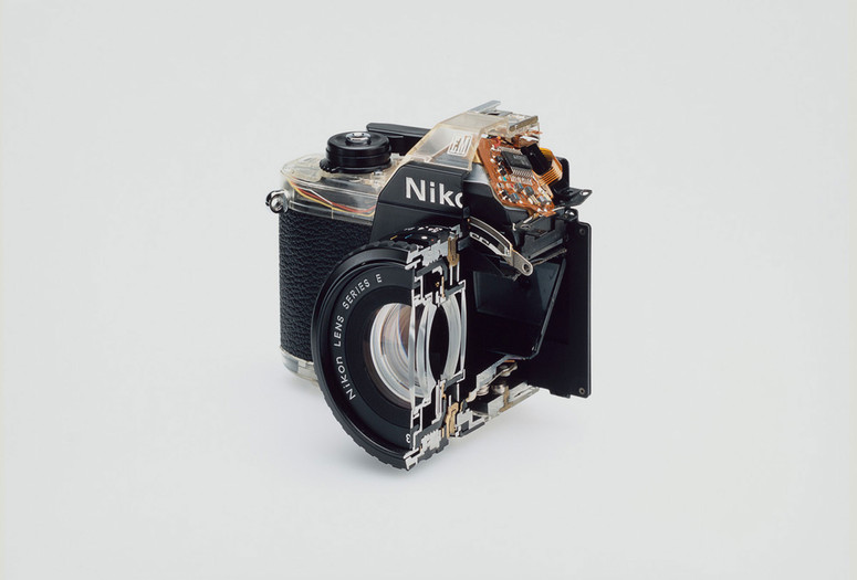 Christopher Williams. Cutaway model Nikon EM. 2008. Shutter: Electronically governed Seiko metal blade shutter vertical travel with speeds from 1/1000 to 1 second with a manual speed of 1/90th; meter: Center-weighted Silicon Photo Diode, ASA 25-1600, EV2-18 (with ASA film and 1.8 lens), Aperture Priority automatic exposure; lens mount: Nikon F mount, AI coupling, (and later) only; flash: Synchronization at 1/90 via hot shoe, Flash automation with Nikon SB-E or SB-10 flash units; focusing: K type focusing screen, not user interchangeable, with 3mm diagonal split image rangefinder; batteries: Two PX-76 or equivalent, 5.3 × 3.38 × 2.13" (135 × 86 × 54 mm). Photography by the Douglas M. Parker Studio, Glendale, California, September 9, 2007–September 13, 2007. Chromogenic print. The Museum of Modern Art, New York. Acquired through the generosity of Helen Kornblum in honor of Roxana Marcoci and Committee on Photography Fund. © 2026 Christopher Williams