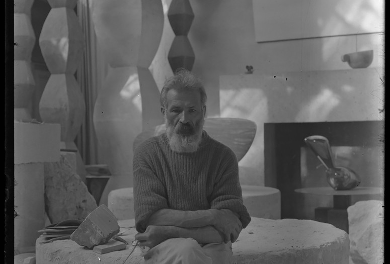 Constantin Brancusi. Self-portrait in the studio with Endless Columns I–IV, Fish (1930), Leda (1926). c. 1934. Glass negative. Centre Pompidou, Paris, Musée national d’art moderne-Centre de création industrielle, Constantin Brancusi Bequest, 1957. Digital image © CNAC/MNAM, Dist. RMN-Grand Palais/Art Resource, NY. © Succession Brancusi – All rights reserved (ADAGP)