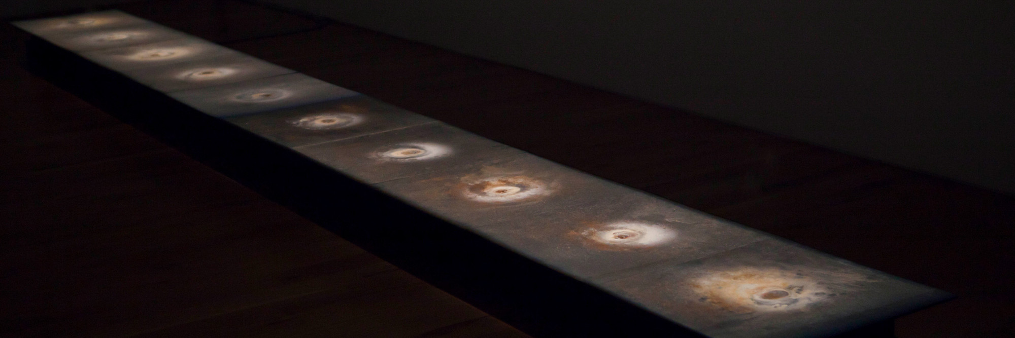 Teresa Margolles. Plancha. 2010. Steel plates, water was absorbed in the places of violent acts, and heating elements. Installation view, Artes Mundi, National Museum Cardiff and Chapter, Wales, United Kingdom, October 2012–January 2013. Courtesy of the artist and National Museum Cardiff. © 2026 Teresa Margolles. Photo: Gabinete TM