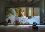 Christopher Kulendran Thomas. Being Human. 2019. High-definition video (color, sound; 24 min.) projected on glass, with three paintings and three sculptures: Untitled II, Untitled V, and Untitled VI (2018) by Upali Ananda, and Untitled II and Untitled V (2018) by Kingsley Gunatillake (all purchased by the artist from Saskia Fernando Gallery, Colombo); and Untitled X after Kingsley Gunatillake (2019) by Christopher Kulendran Thomas. In collaboration with Annika Kuhlmann. The Museum of Modern Art, New York. Acquired through the generosity of Charles Asprey and Markus Hannebauer. © 2026 Christopher Kulendran Thomas
