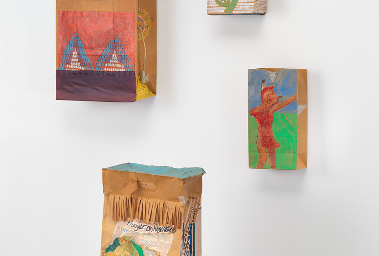 From left: G. Peter Jemison. Art Bag. 1980. Crayon, oil pastel, fabric, rope, plastic tag, jigsaw puzzle piece, and ticket with oil paint on printed brown paper bag with three printed metal pins and a business card inside, 20 × 13 × 7" (50.8 × 33 × 17.8 cm). The Museum of Modern Art, New York. Frances Keech Fund; G. Peter Jemison. Number One. 1980. Gouache, crayon, metallic paint, and pencil on printed brown paper bag with a corn husk inside, 13 3/4 × 7 1/16 × 4 1/8" (35 × 18 × 10.5 cm). The Museum of Modern Art, New York. Acquired through the generosity of Agnes Gund; G. Peter Jemison. Indian Toy / Toy Indian. 1984. Gouache, crayon, pencil, and colored pencil on printed brown paper bag, 13 3/4 × 6 7/8 × 4 1/2" (34.9 × 17.5 × 11.4 cm). The Museum of Modern Art, New York. Acquired through the generosity of Marnie Pillsbury; G. Peter Jemison. Hunger on Reservations While Children in Africa Starve. 1981. Gouache, crayon, marker, pen, colored pencil, and cut-and-pasted paper and board on printed brown paper bag, 19 5/16 × 11 3/4 × 6 3/4" (49 × 29.8 × 17.2 cm). The Museum of Modern Art, New York. Frances Keech Fund