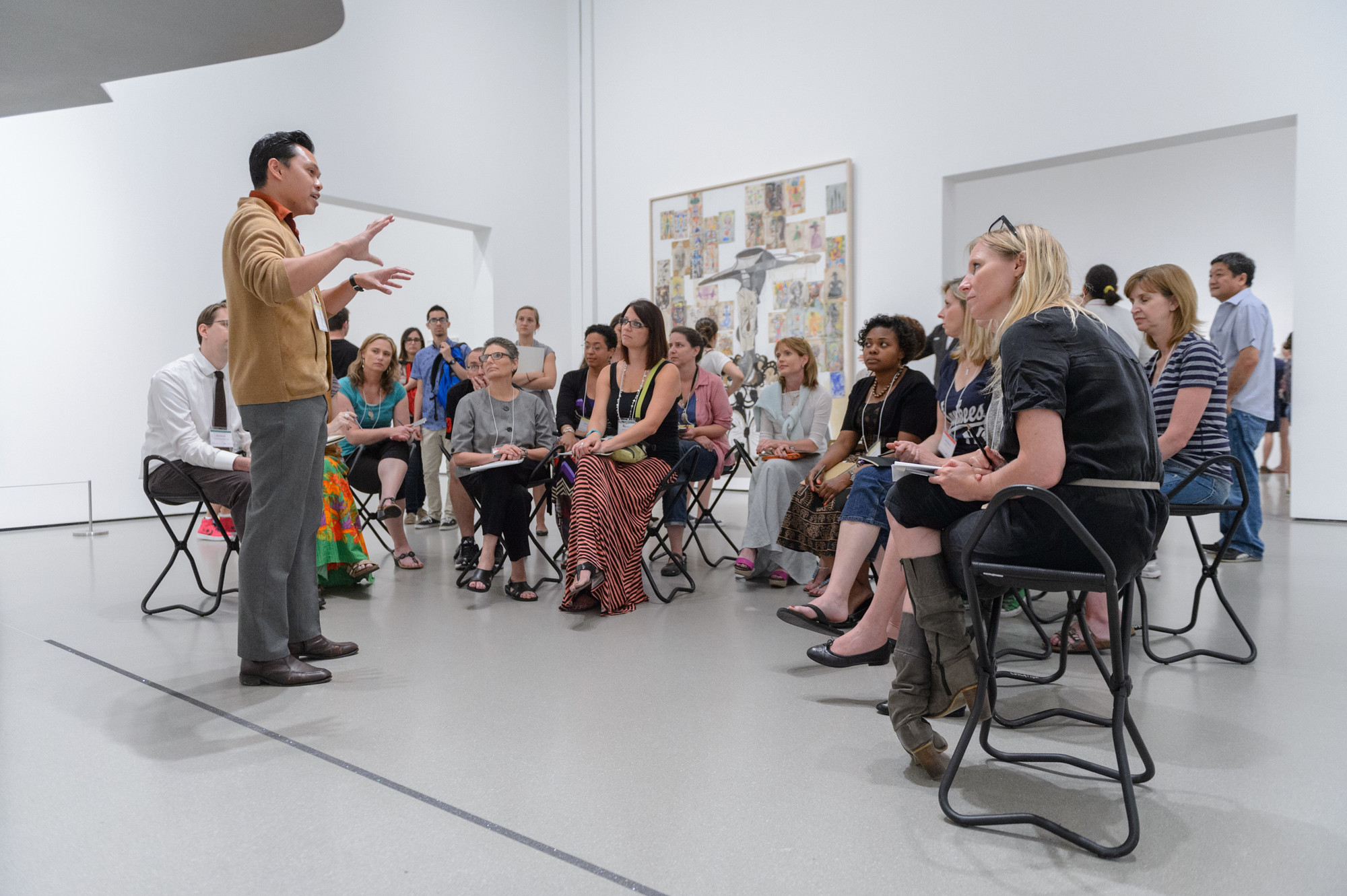 MoMA educator Francis Estrada speaking with teachers during Connecting Collections: Summer Institute for Teachers. 2013. Photo: Filip Wolak