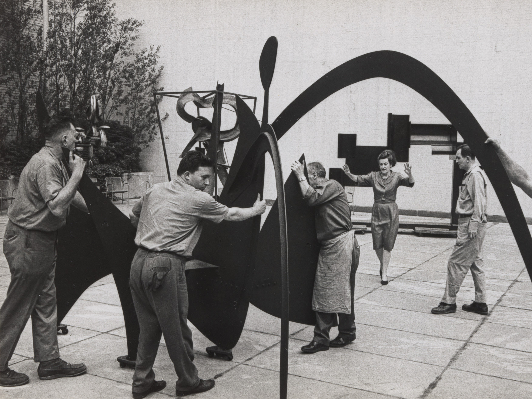 Dorothy Miller installing Alexander Calder’s Black Widow (1959). Photo: Dan Budnik