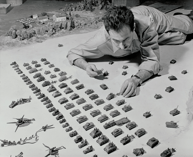 "Sterling silver models of tanks, jeeps, trucks, etc." being installed during exhibition. Exhibition Dates: January 26, 1944 through March 5, 1944. Photographic Archive. The Museum of Modern Art Archives, New York. Photographer, Herbert Gehr