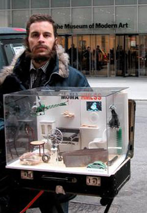 Photo of Filip Noterdaeme holding the MoMA HMLSS museum-in-a-suitcase