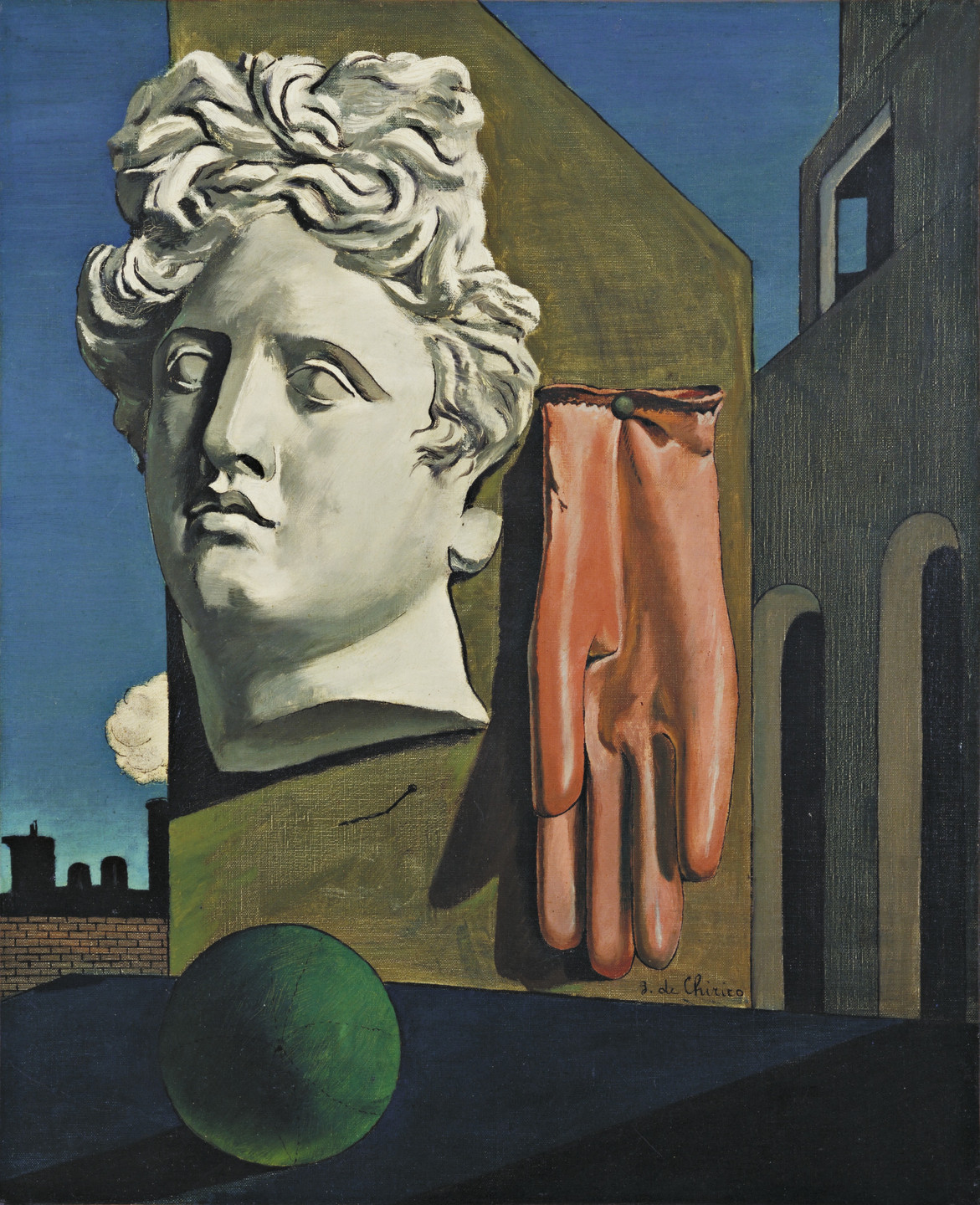A stone head with wavy hair and a red glove are mounted on a structure next to a green ball against a dark blue sky with silhouettes of buildings in the background. This is an AI generated description. To give feedback, email ai@moma.org.