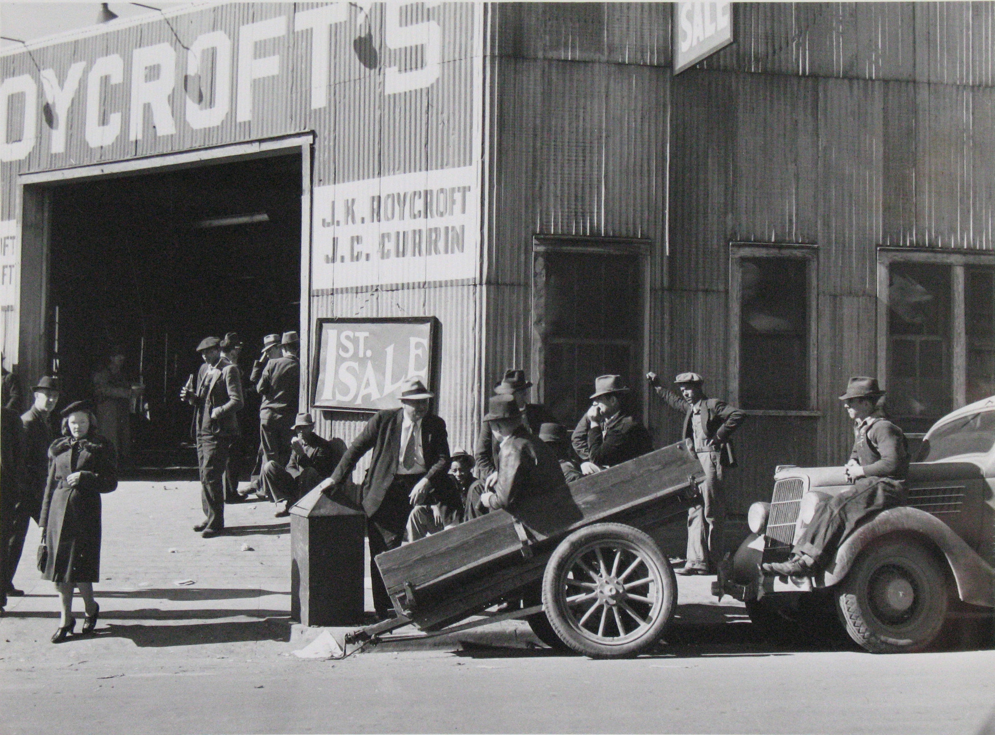 Marion Post Wolcott. Many Stories are Exchanged by Buyers and Farmers While Waiting Around Outside Warehouse During Auction Sales. Durham, North Carolina. 1939
