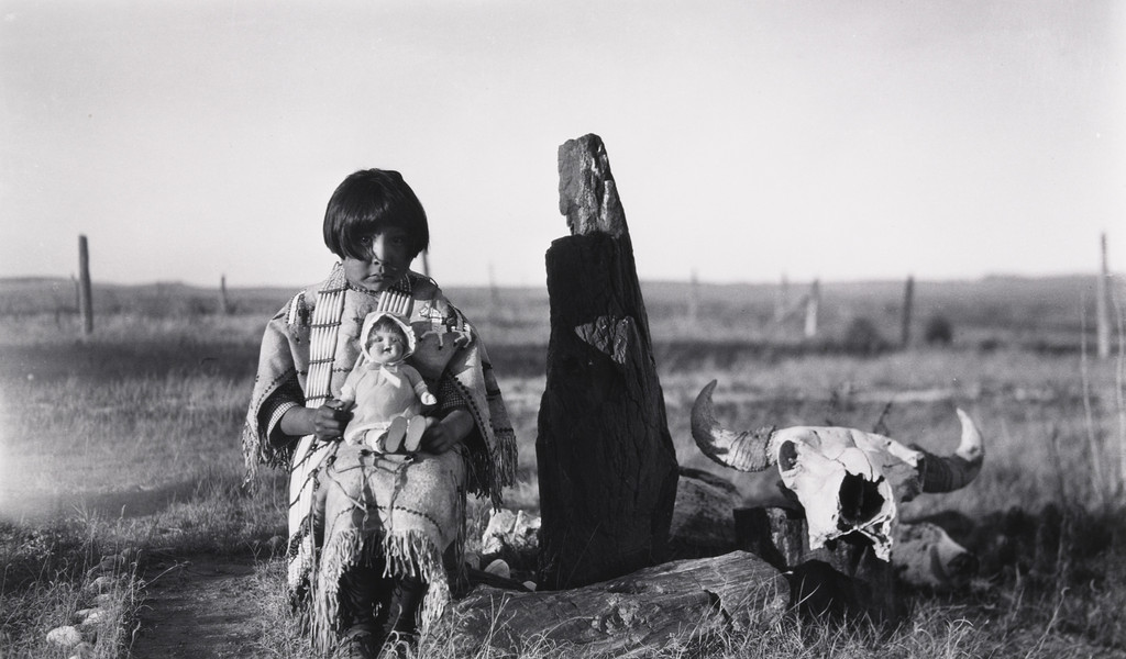 Marie Cow Killer With Doll given by Elaine and Alice Boyle, Petrified Wood and Buffalo Skull,
