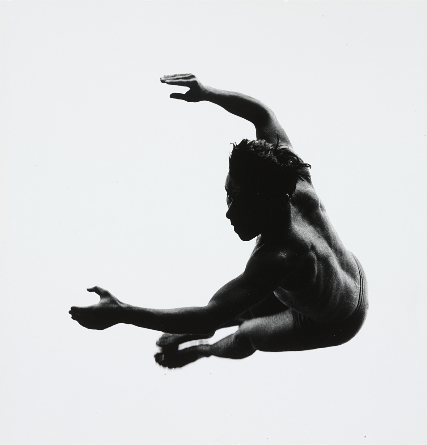 Silhouette of a person mid-air in a dynamic pose with arms and legs extended. Black figure on a white background. This is an AI generated description. To give feedback, email ai@moma.org.
