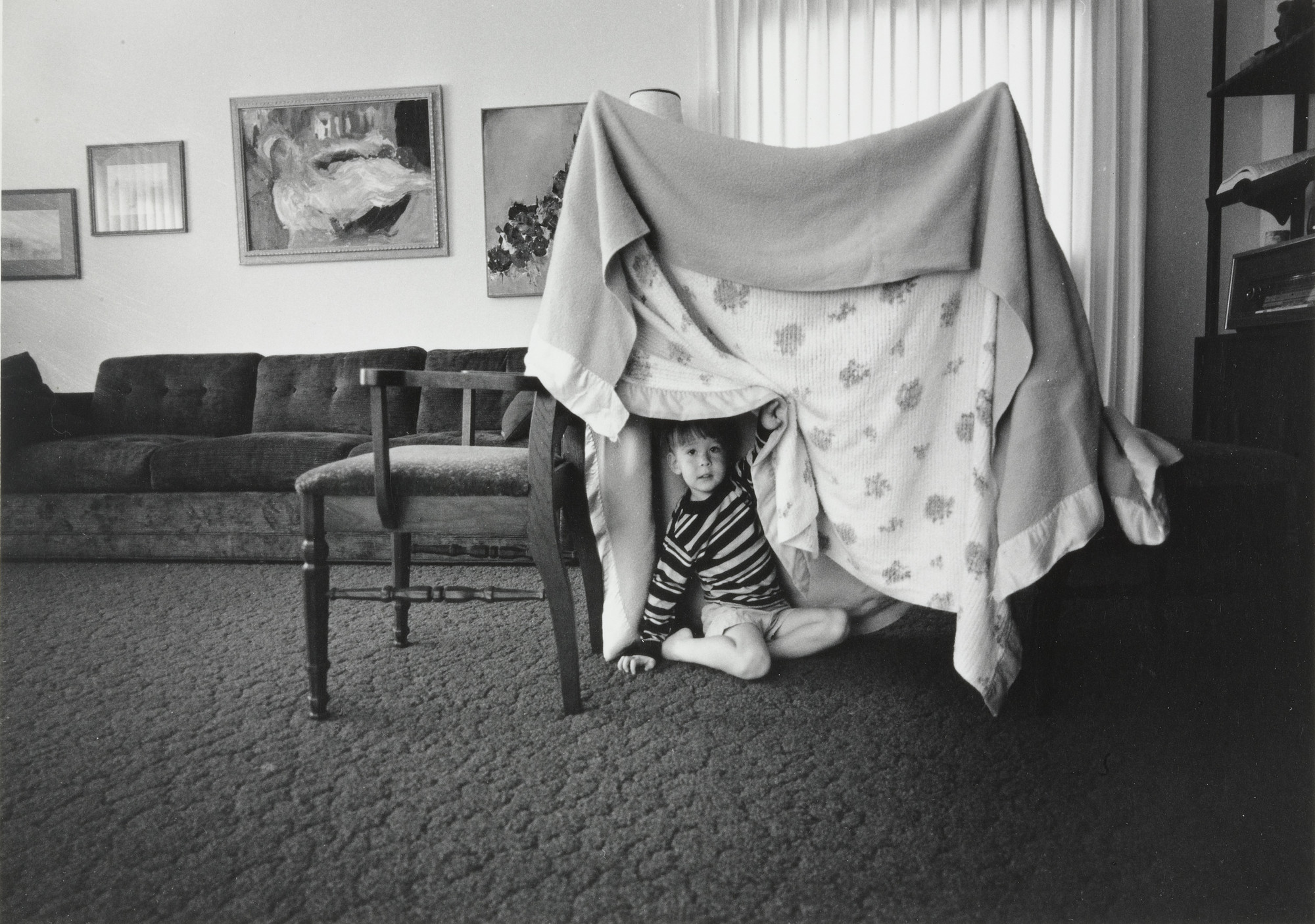 Bill Owens. Some days when there is no one to play with I build Glenn a tent play house out of two chairs and two blankets.. 1971
