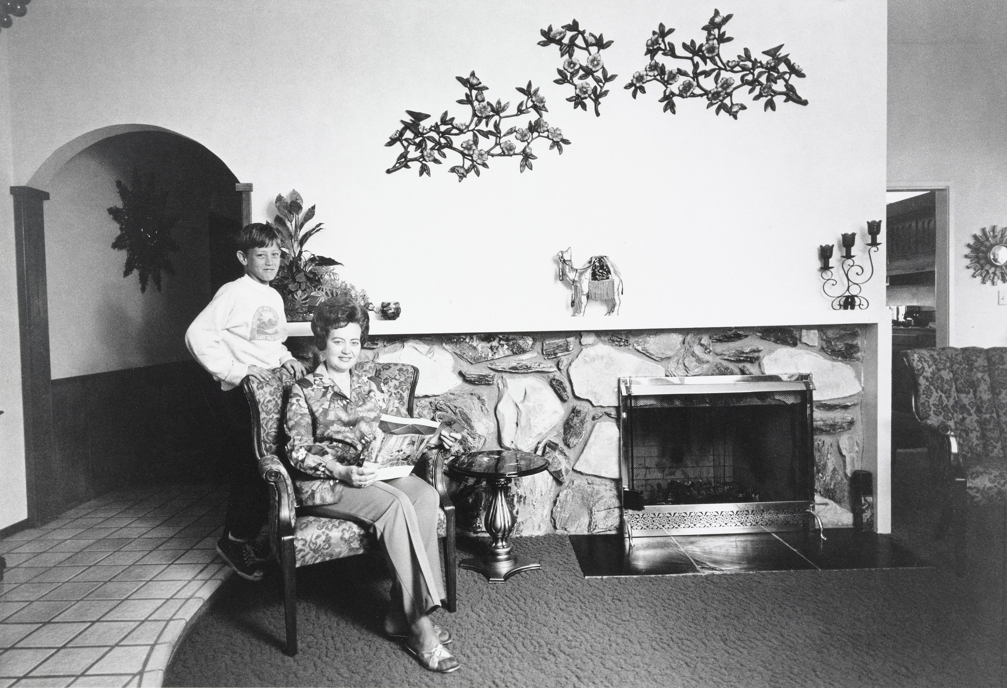 Bill Owens. I get a lot of compliments on the front room wall. I like Italian Syrocco floral designs over the mantle. It goes with the Palos Verde rock fireplace.. 1972