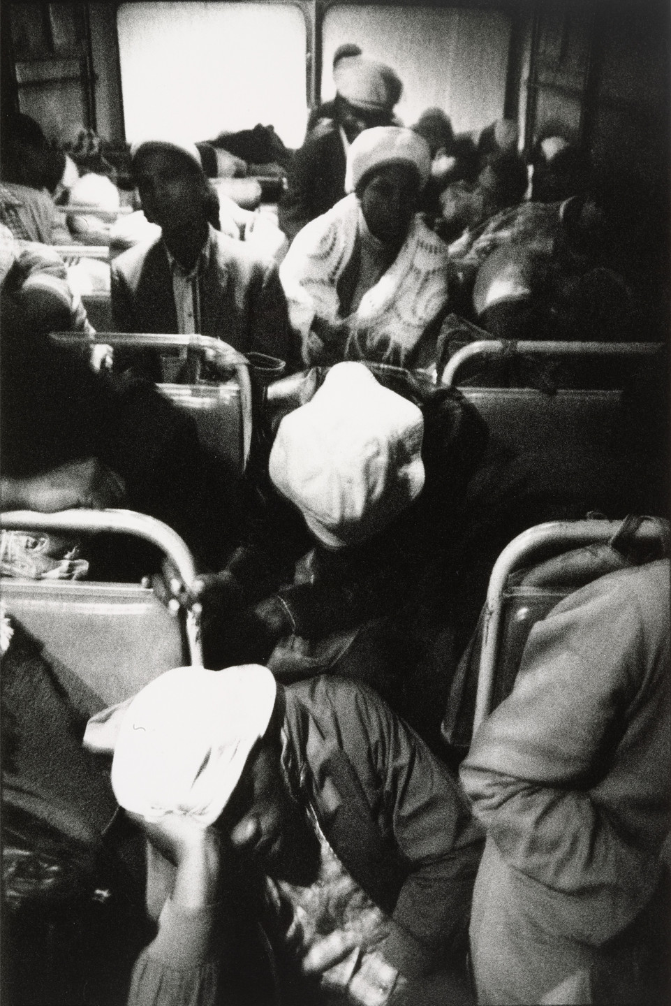 David Goldblatt. The Transported of Kwa Ndebele: Going to Work - 3:30am Wolwekraal-Marabastad Bus, Standing Passengers Have Slumped to the Floor. 1983
