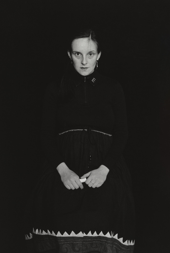 Graz. (seated in dark dress)