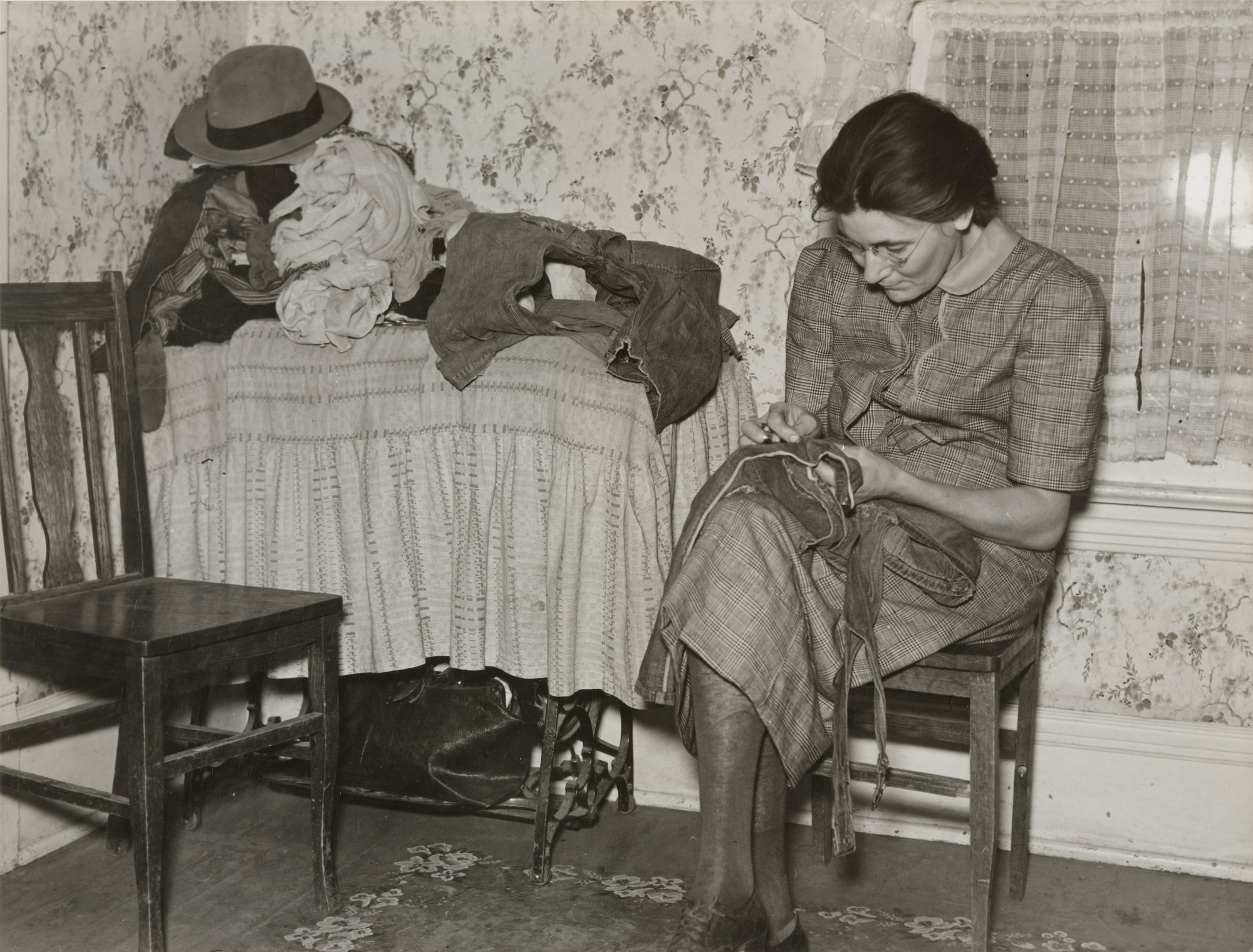 Russell Lee. Mrs. Gallagher Patching Clothes for her Children, Wife of Former Farmer, Now Living in Crosby, North Dakota, Woman Patching Clothes, North Dakota