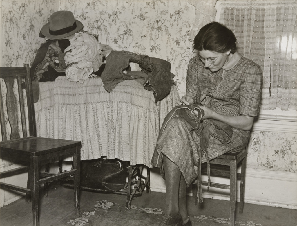Mrs. Gallagher Patching Clothes for her Children, Wife of Former Farmer, Now Living in Crosby, North Dakota, Woman Patching Clothes, North Dakota
