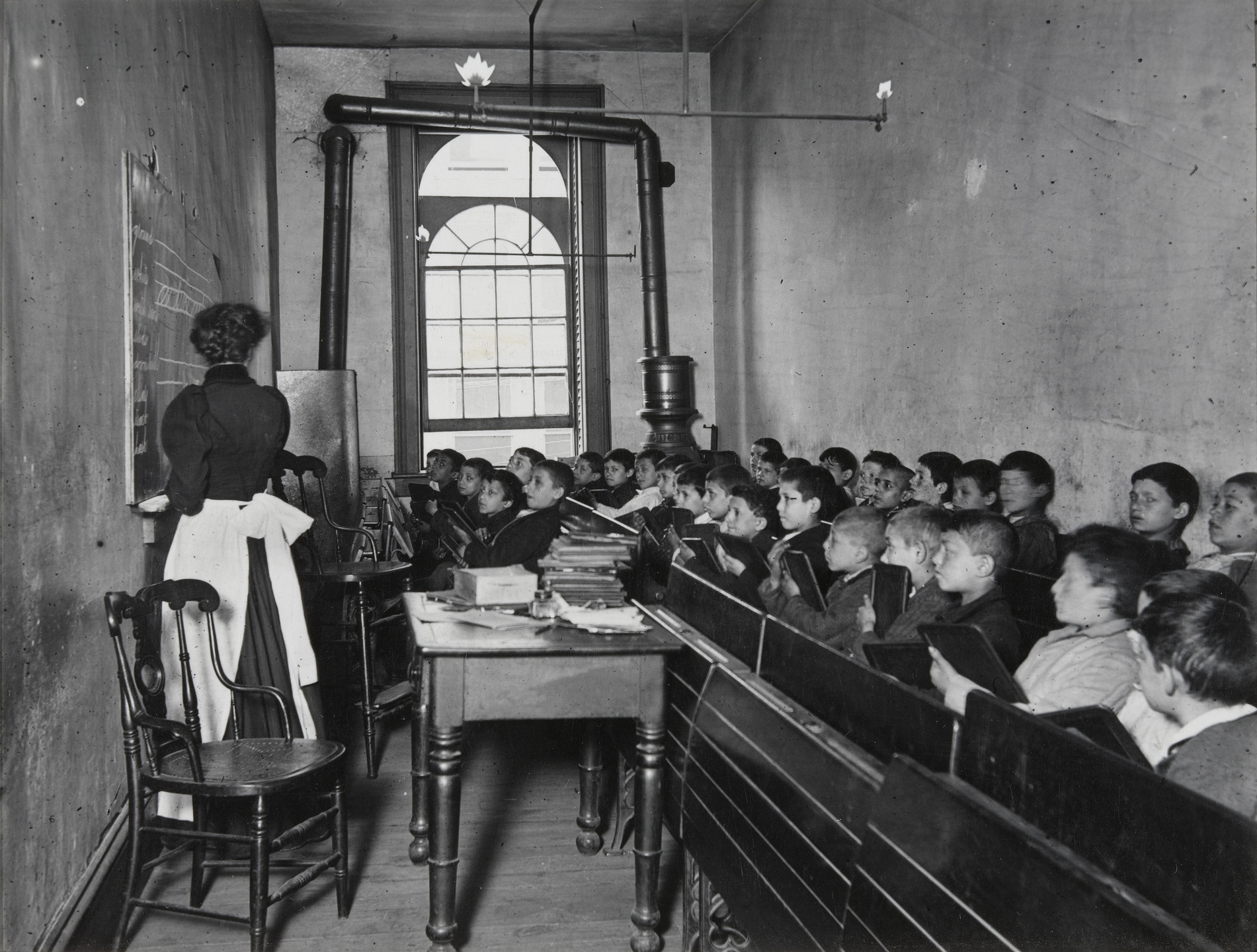 Jacob August Riis. East Side Public School. A Class in the Condemned Essex Market School. Gas burning by day. 1888-95