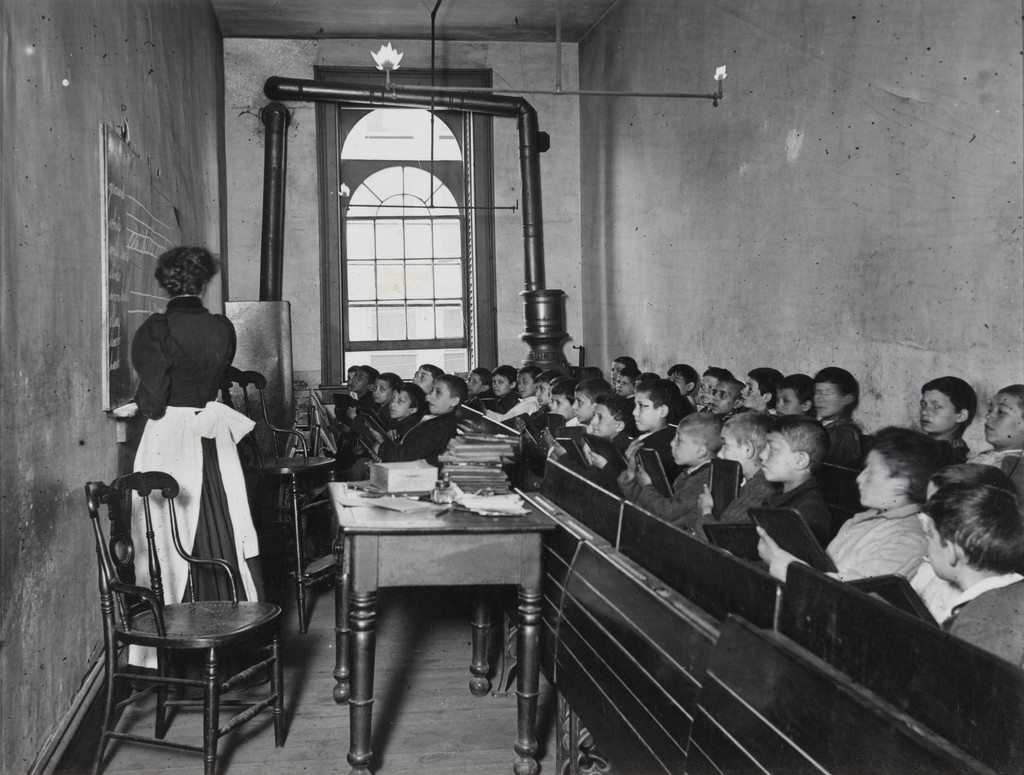 East Side Public School. A Class in the Condemned Essex Market School. Gas burning by day