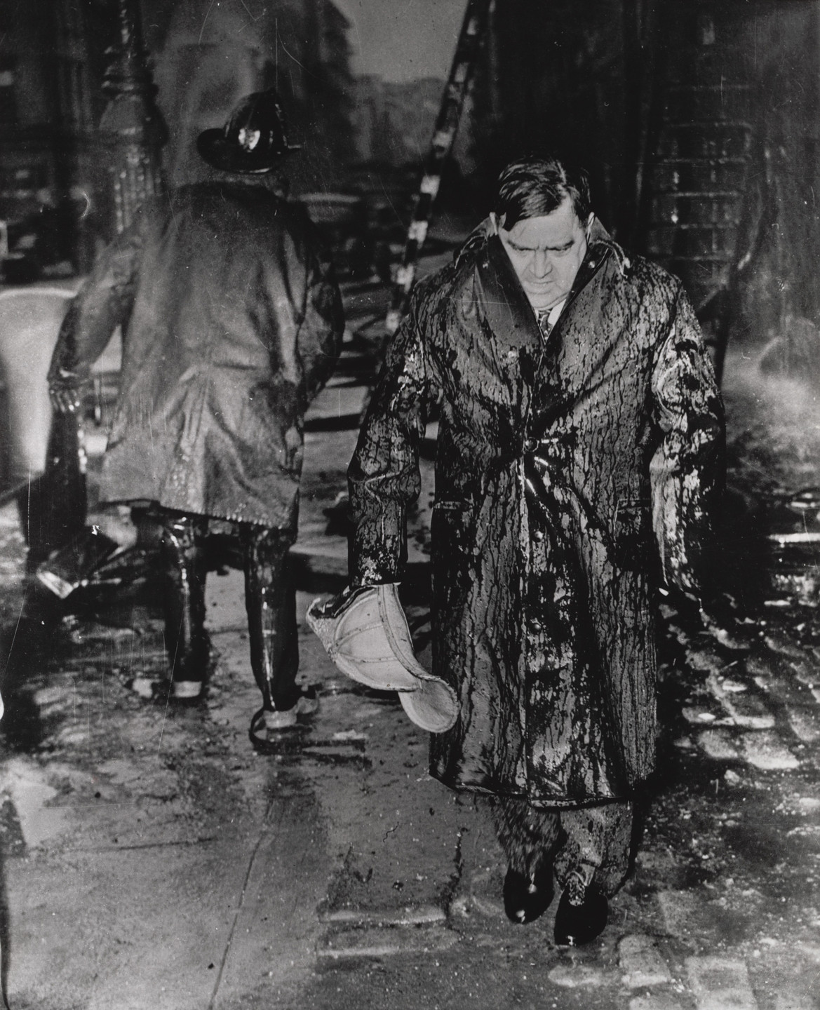 Bettmann/United Press International. "Leaving a Fire in Drenched Raincoat and Helmet". 1939