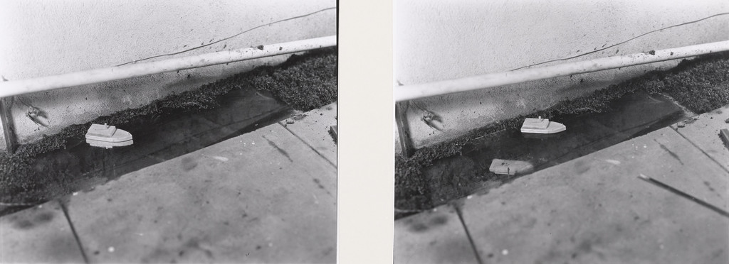 Toy Boat Afloat in Small Pond; Upon Setting Sail, Sinks Reflection