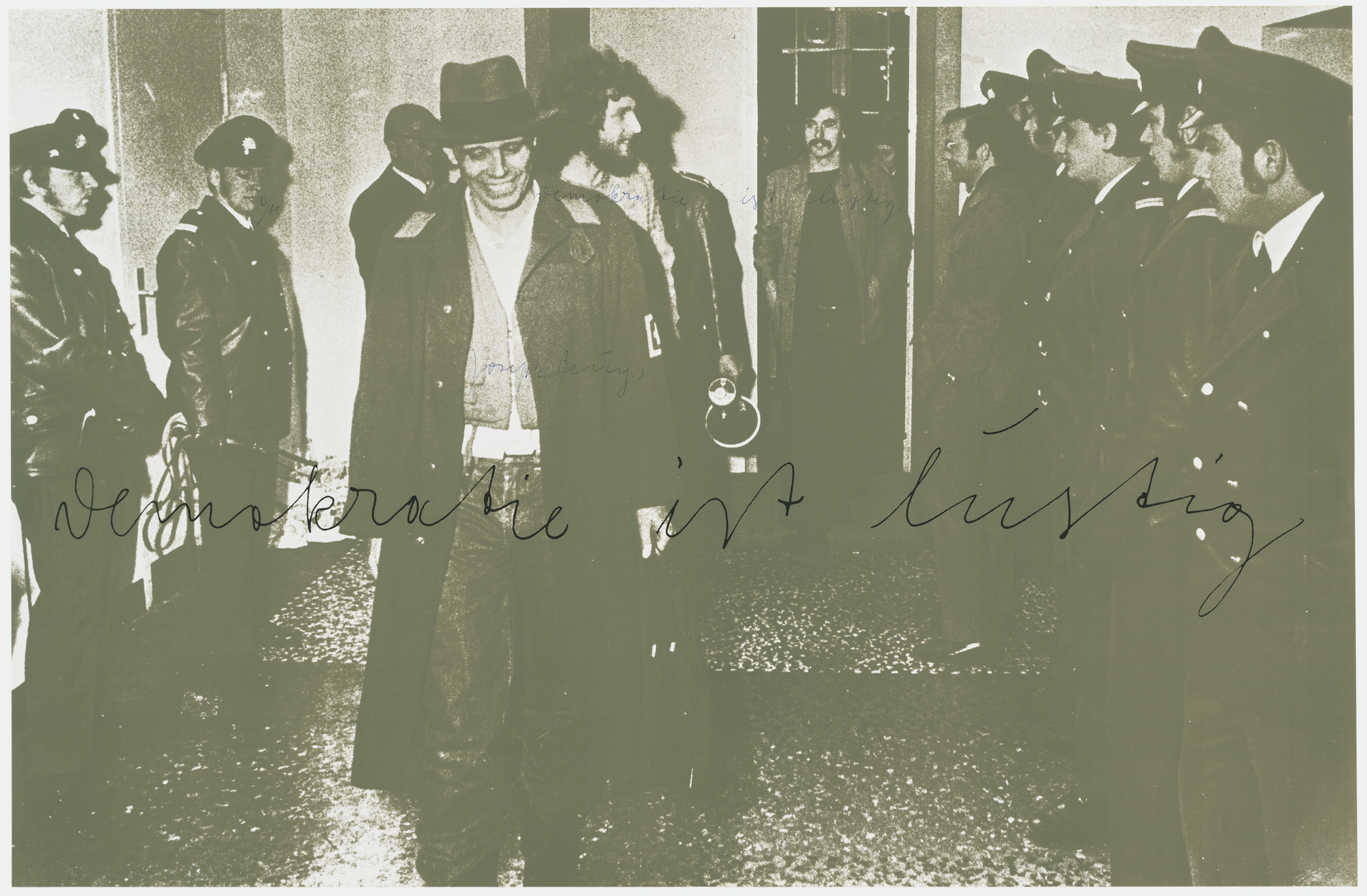 A group of men in uniforms are lined up on both sides of a corridor, with a man in a hat and coat walking towards the camera and others in casual clothes in the background. Predominant colors are shades of green and black. This is an AI generated description. To give feedback, email ai@moma.org.