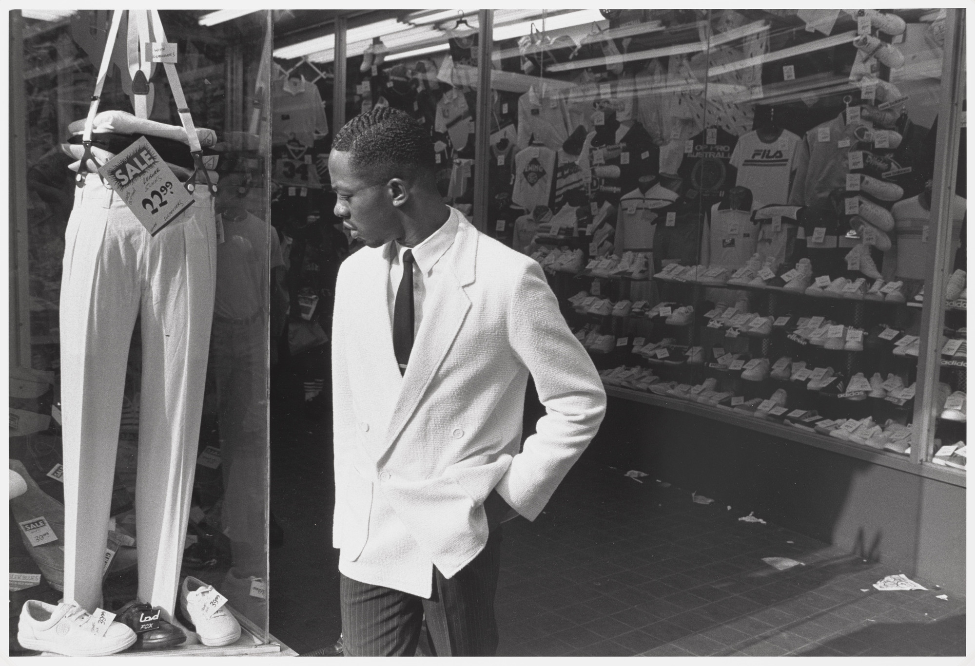 Dawoud Bey. A Man Looking at Pants on Fulton Street. 1985