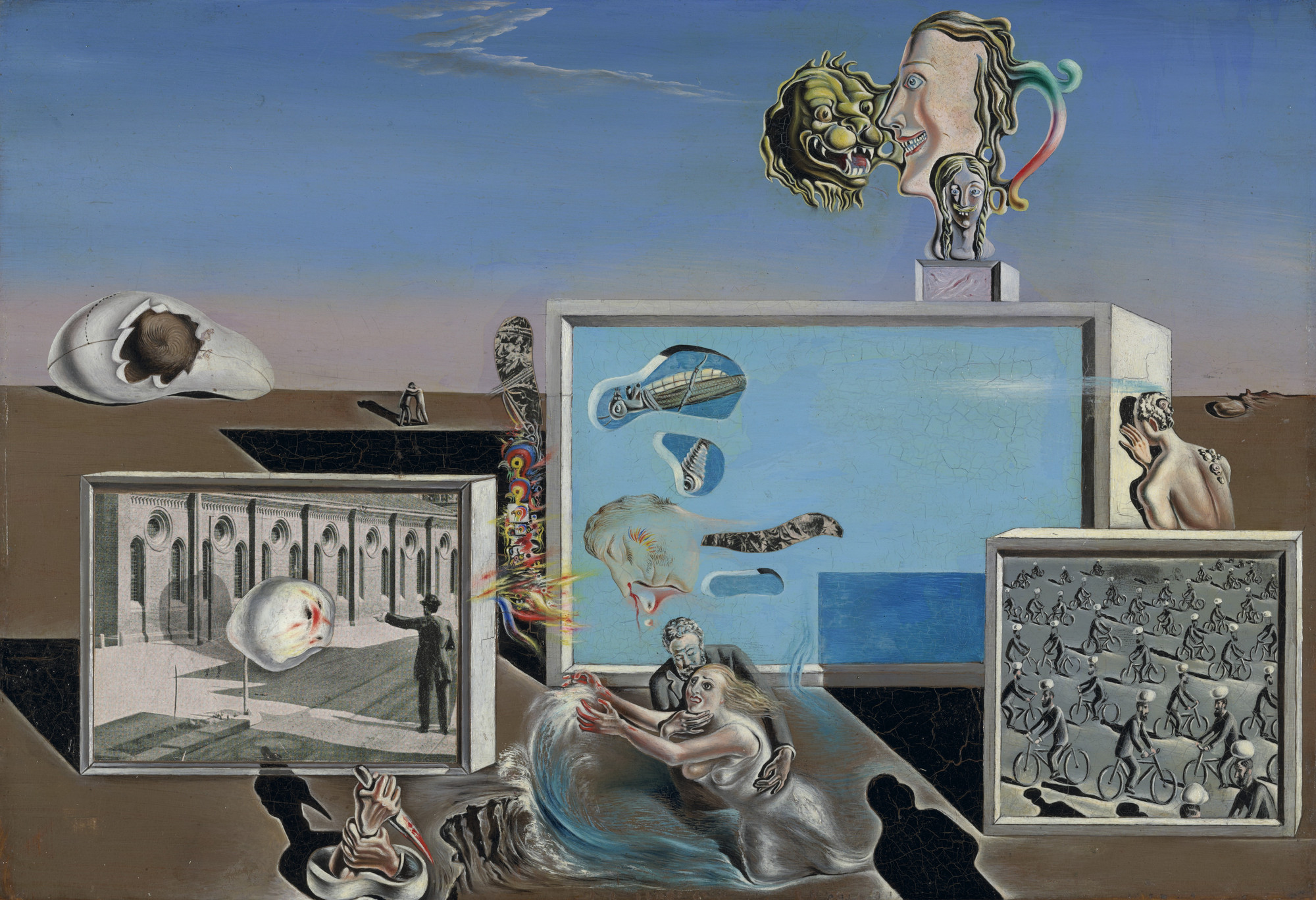 The painting features various disconnected objects including human faces, a large cracked skull, a couple in an embrace, and a grid of cyclists, set against a blue and brown landscape. Predominant colors are blue, brown, and beige. This is an AI generated description. To give feedback, email ai@moma.org.