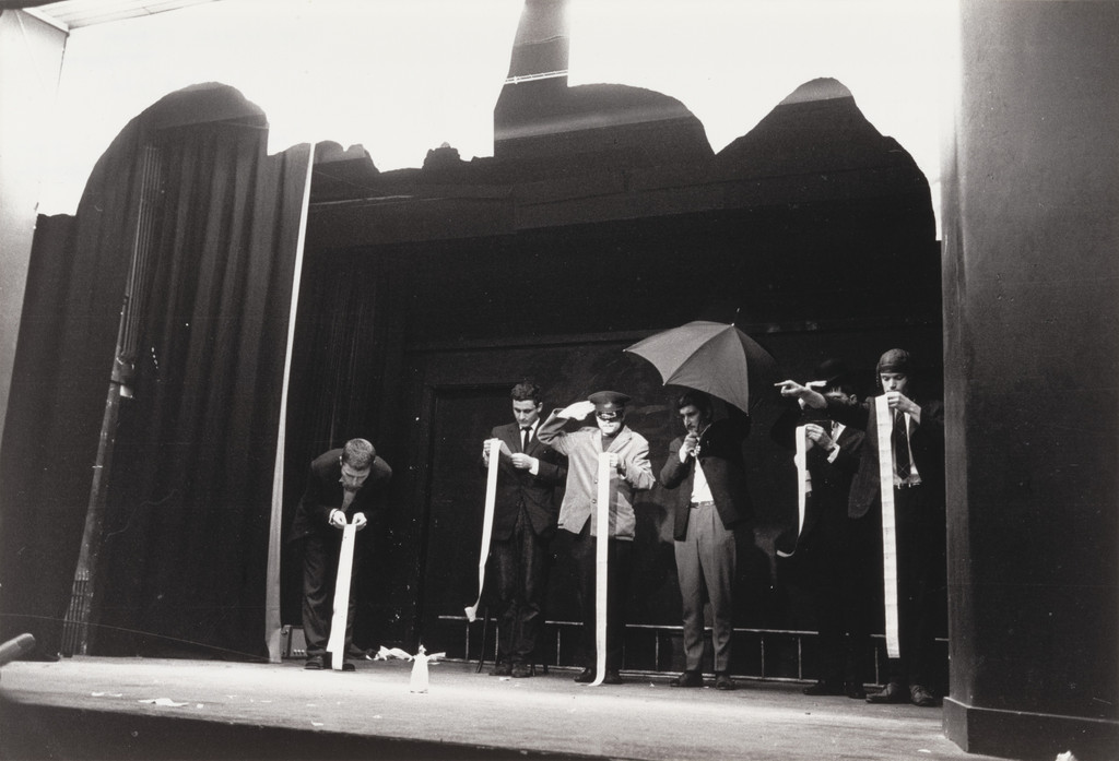 In Memoriam to Adriano Olivetti Version 3 Ballet, performed during Fluxus Festival/Theatre Compositions/Street Compositions/Exhibits/Electronic Music, Hypokriterion Theater, Amsterdam, June 23, 1963 by George Maciunas