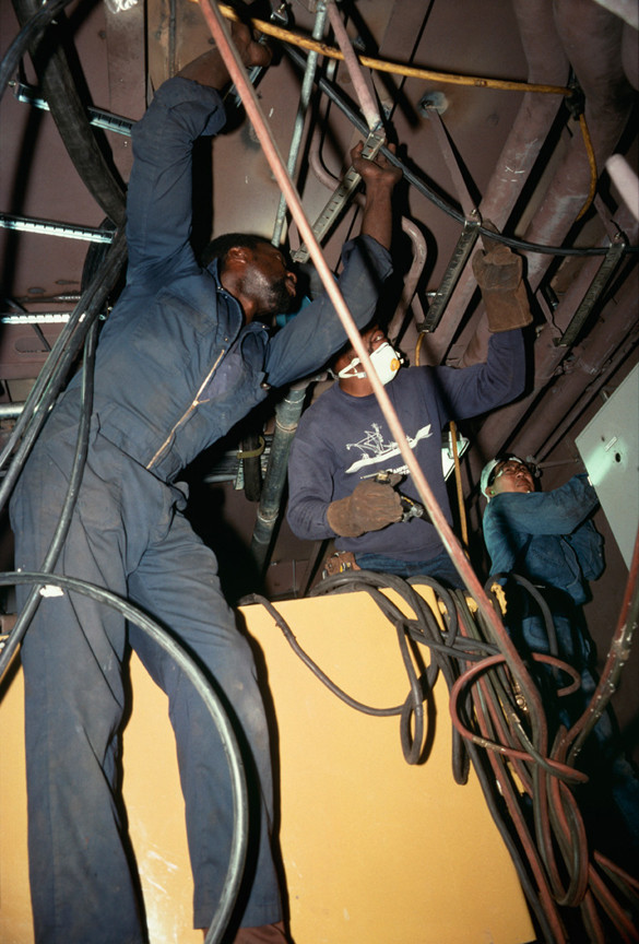 Allan Sekula. Pipe fitters finishing the engine room of a tuna-fishing boat. Campbell Shipyard. San Diego harbor from the series Fish Story. August 1991